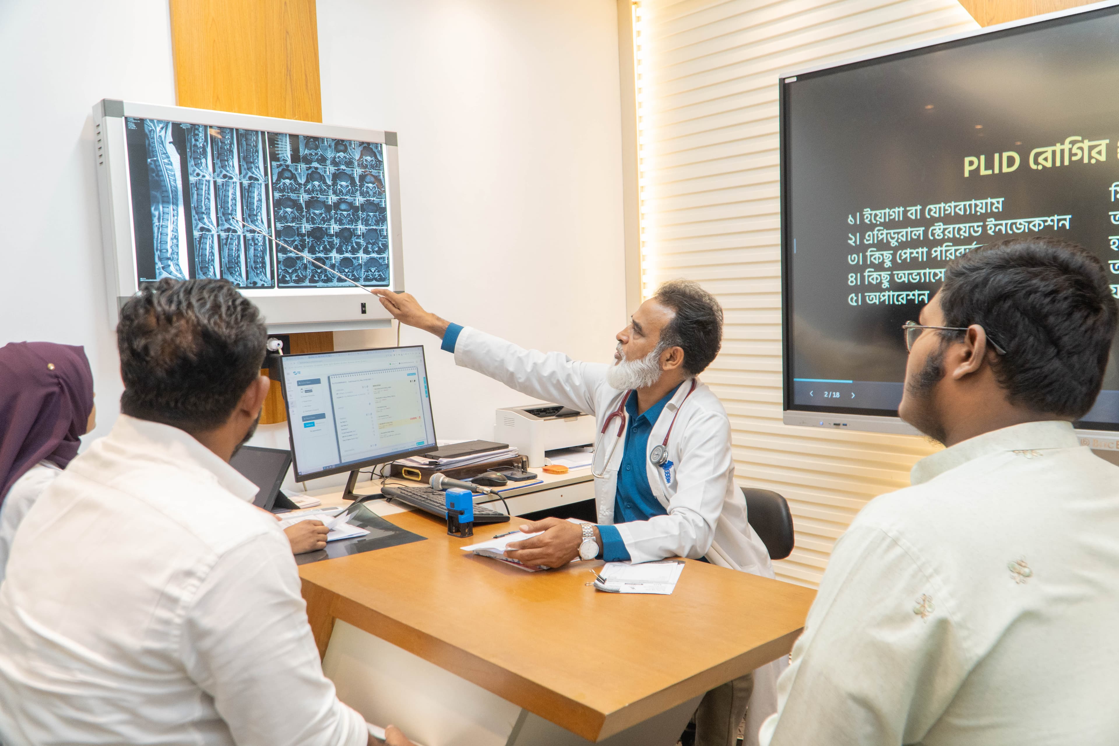 Dr. Shah Alam consulting with a patient in a modern office
